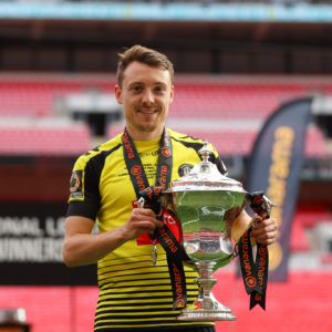 Jacket Emmet holding a trophy